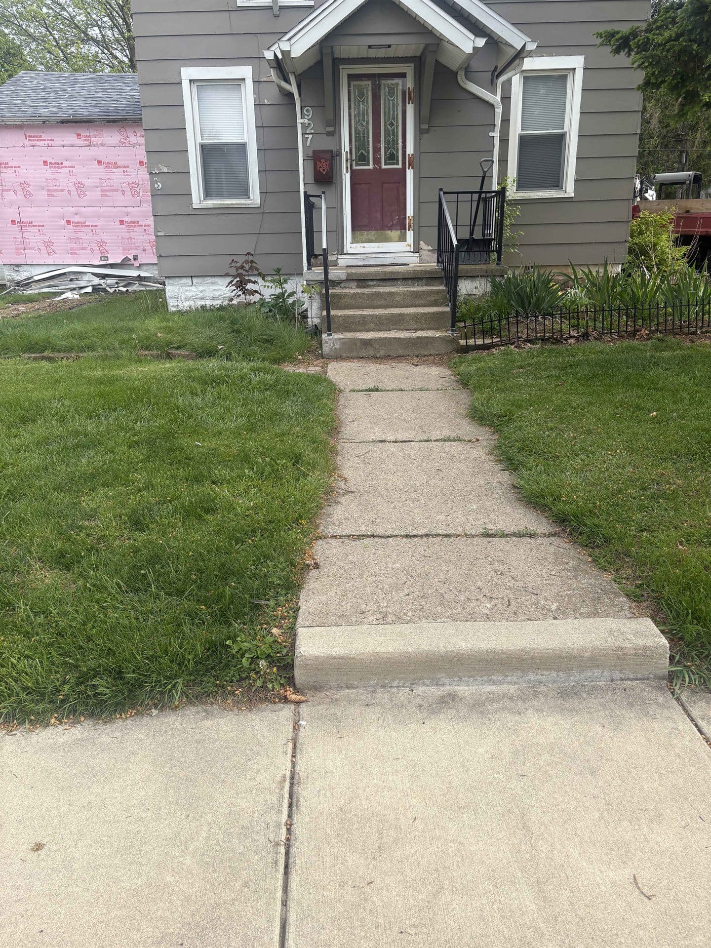 A new concrete walkway leading to a home's front steps