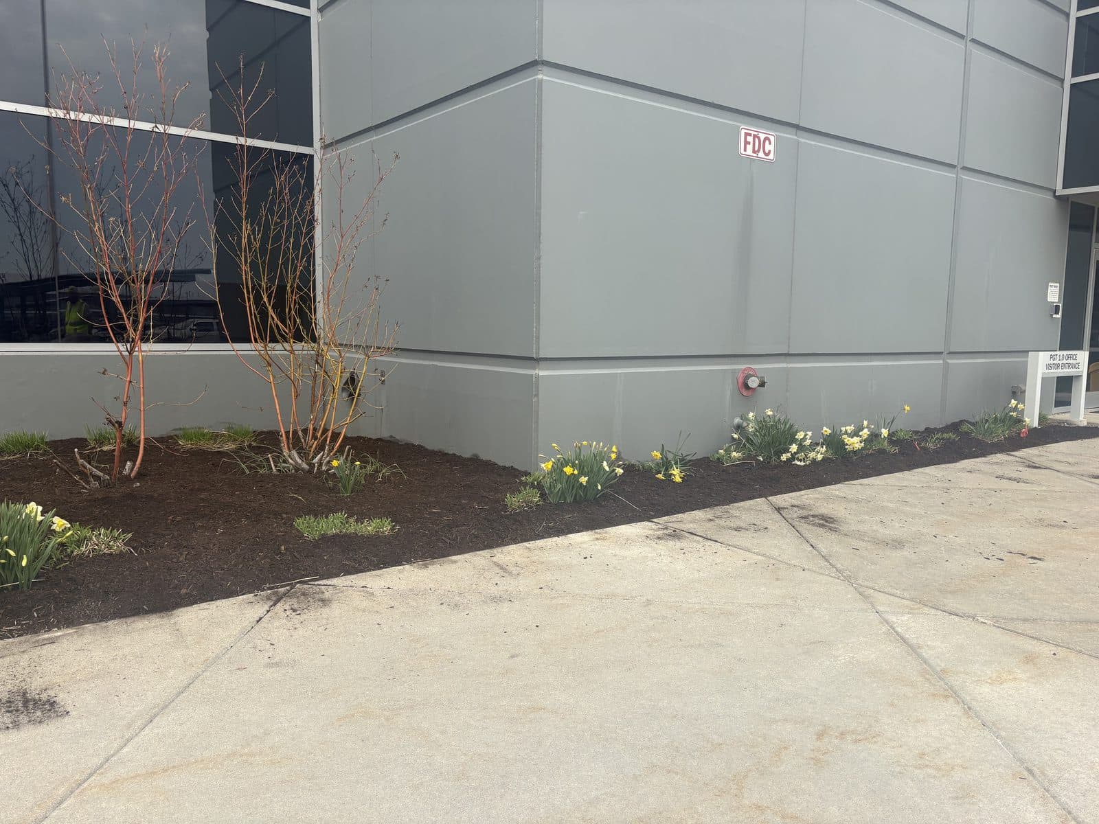 A finished concrete sidewalk along a commercial building